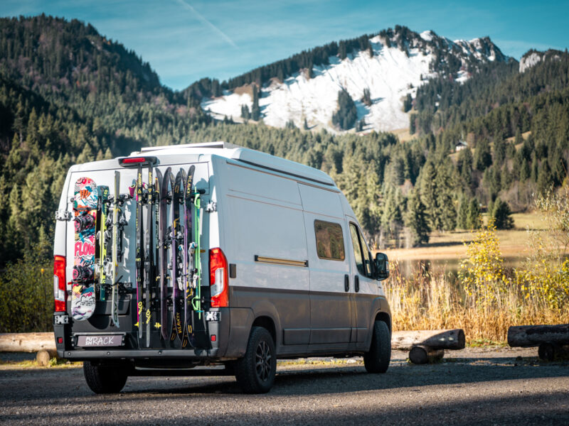 Fiat Ducato with a PUSHrack Ski Rack carrying five pairs of skis, two pairs of cross-country skis, and one snowboard