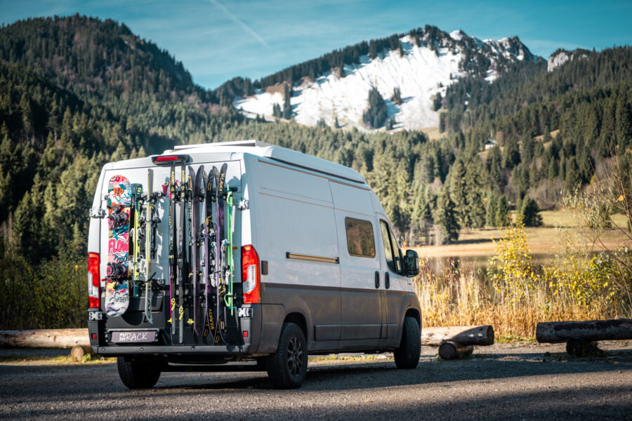 Fiat Ducato with a PUSHrack Ski Rack carrying five pairs of skis, two pairs of cross-country skis, and one snowboard