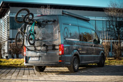 PUSHrack bike rack V3 attached to the rear of a campervan with a gravel bike and a children's bike