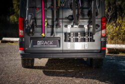 PUSHrack leveling wedges mounted on the PUSHrack Room Extender on airline rails at the rear of a camper van