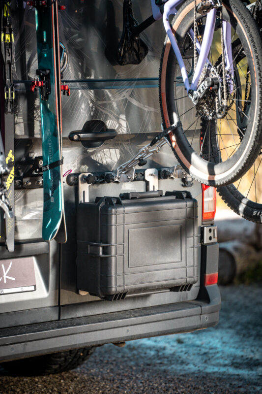 PUSHrack box mounted below two bicycles on a campervan, showing the PUSHrack bike rack with tyre holder and gravel adapter
