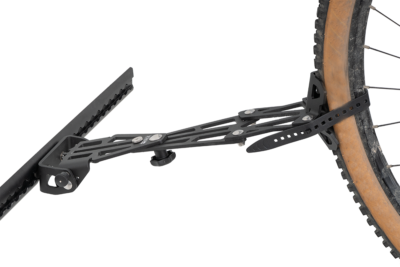 Gravel adapter mounted on airline rail and secured to gravel bike tire on PUSHrack V3 rear door rack